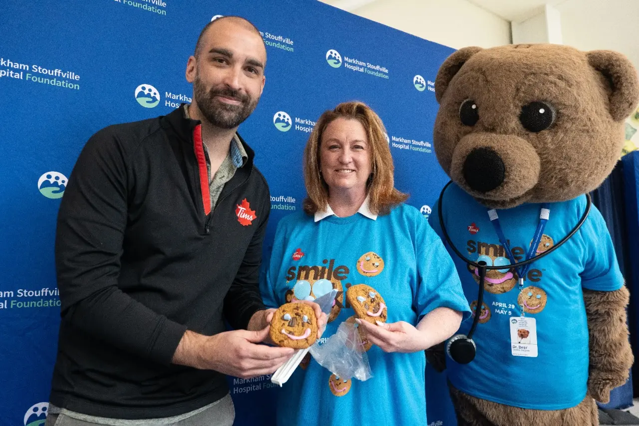 Allan Bond Suzette Strong & Dr. Bear mascot sharing smiles for the return of  Smile Cookie