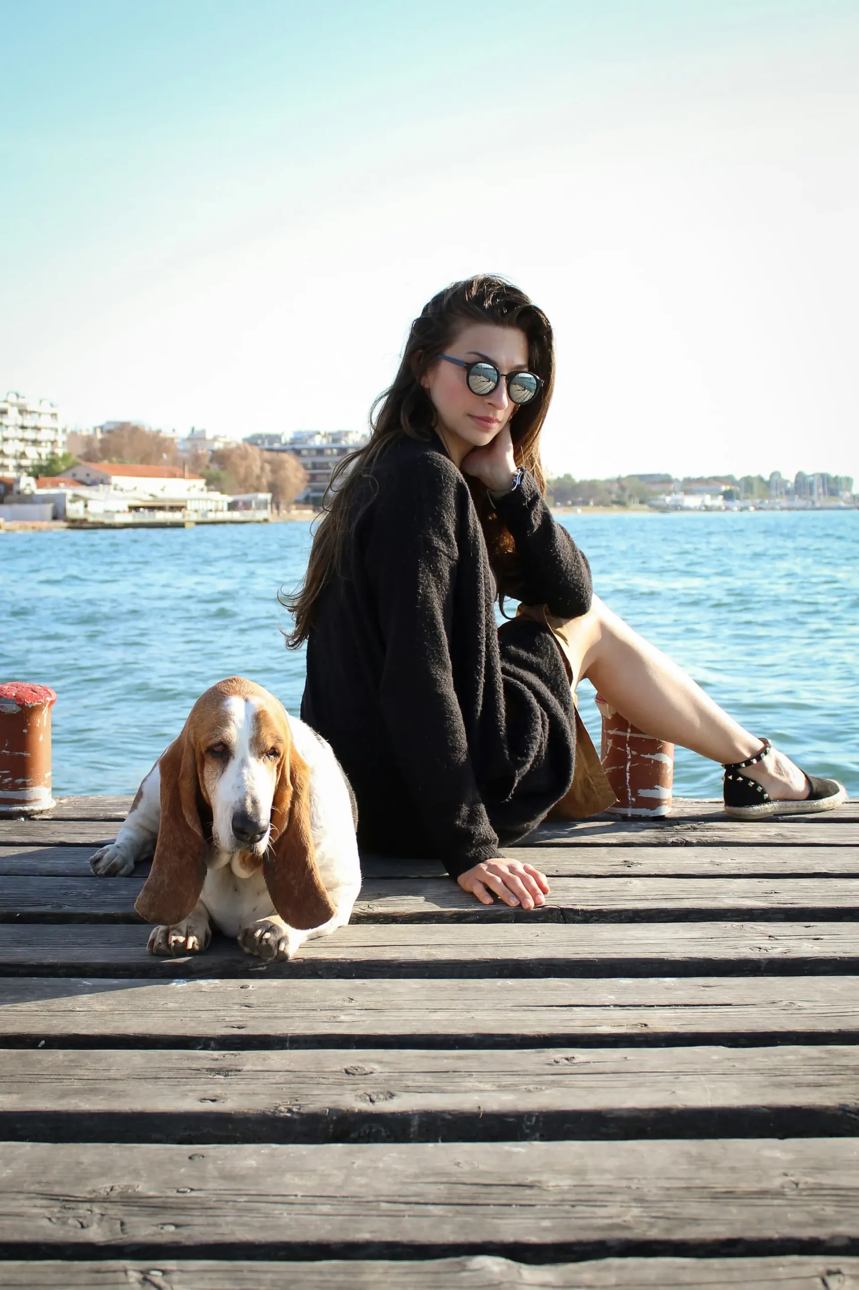 National_Dog_Day_2024_female_and_dog_sit_at_the_port